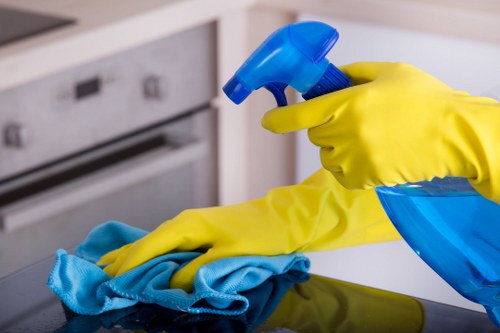 Professional cleaner preparing a tidy room in CR0